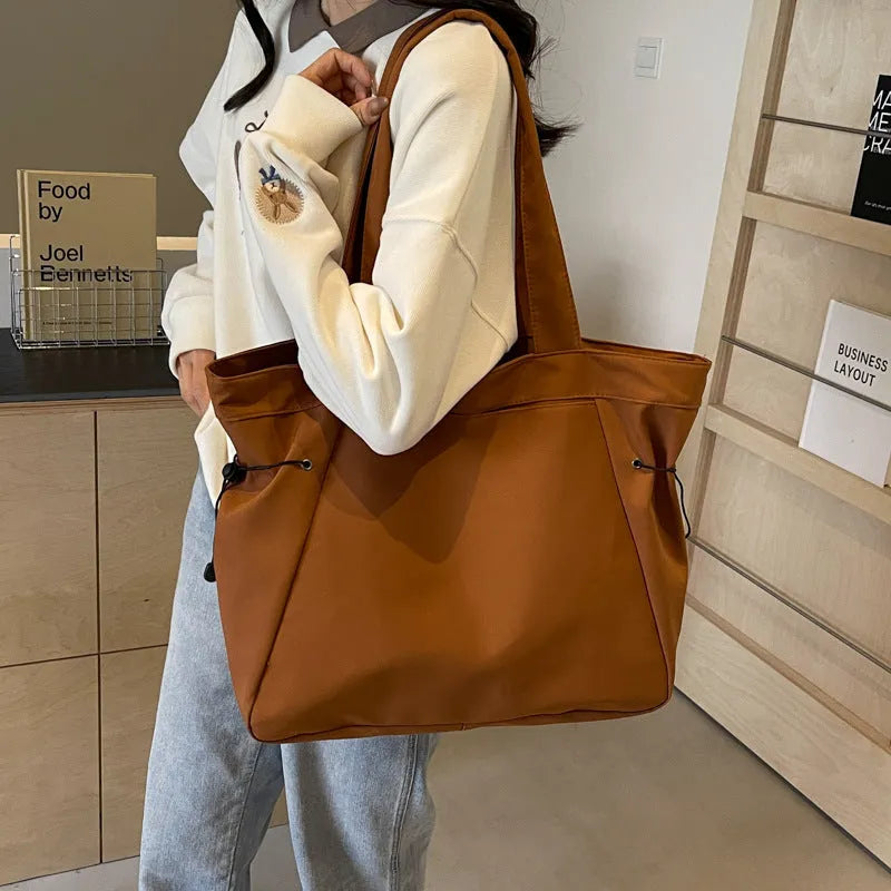 Soft folding Oxford cloth tote bag in a street style, shown in multiple colour options.