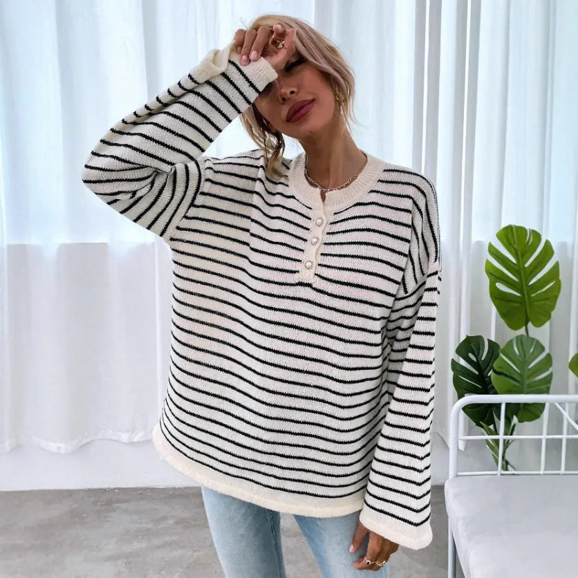 Women's black and white striped loose top with drop-shoulder sleeves and button details