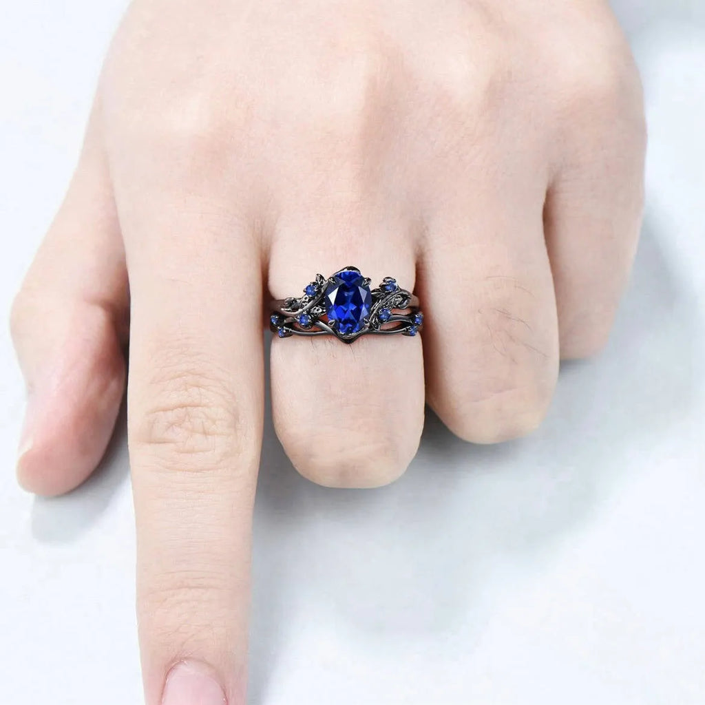 Black gun finish women's ring with navy blue rhinestone inlay on copper geometric band