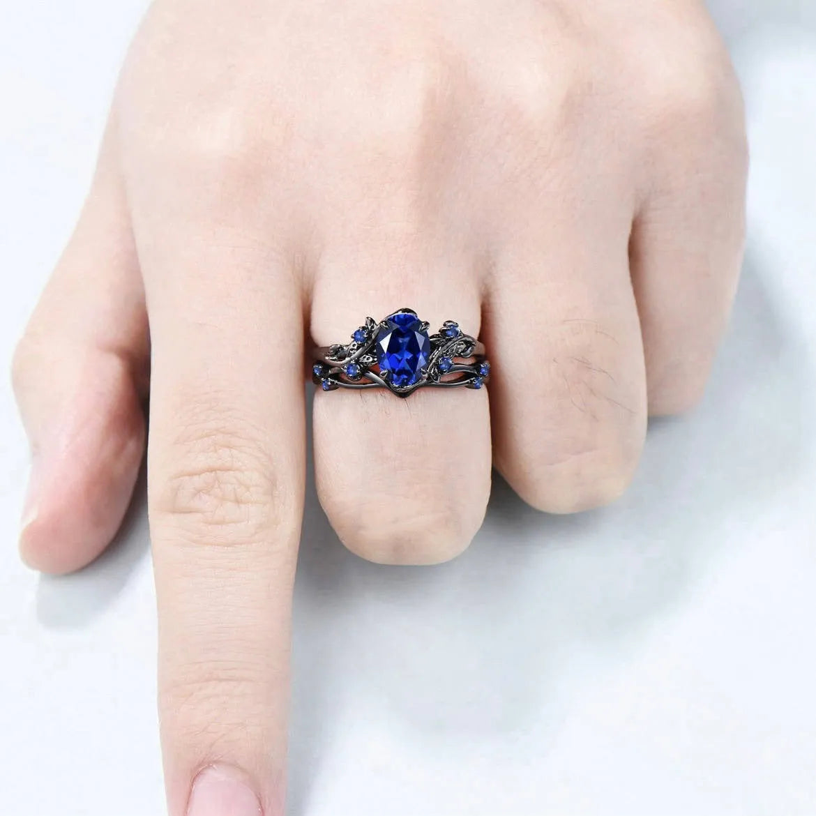 Black gun finish women's ring with navy blue rhinestone inlay on copper geometric band