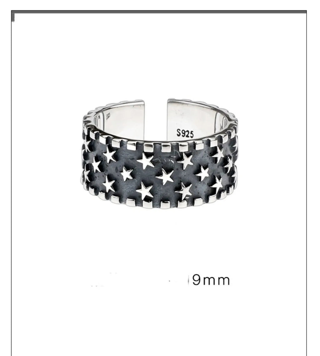 Adjustable open-band sterling silver ring with a raised five-pointed star geometric design.