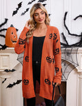 Women's black Halloween cardigan with jacquard-knitted orange pumpkin head pattern, shown as a straight-cut medium-length coat.