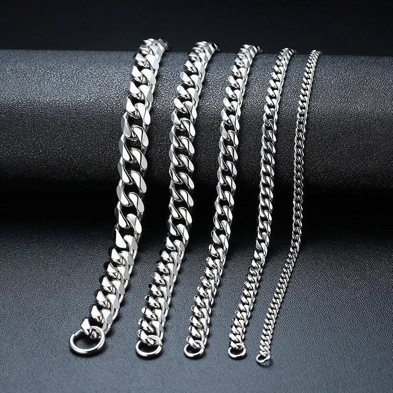 Six-sided geometric Cuban link chain metal bracelet in a gold finish on a wrist.