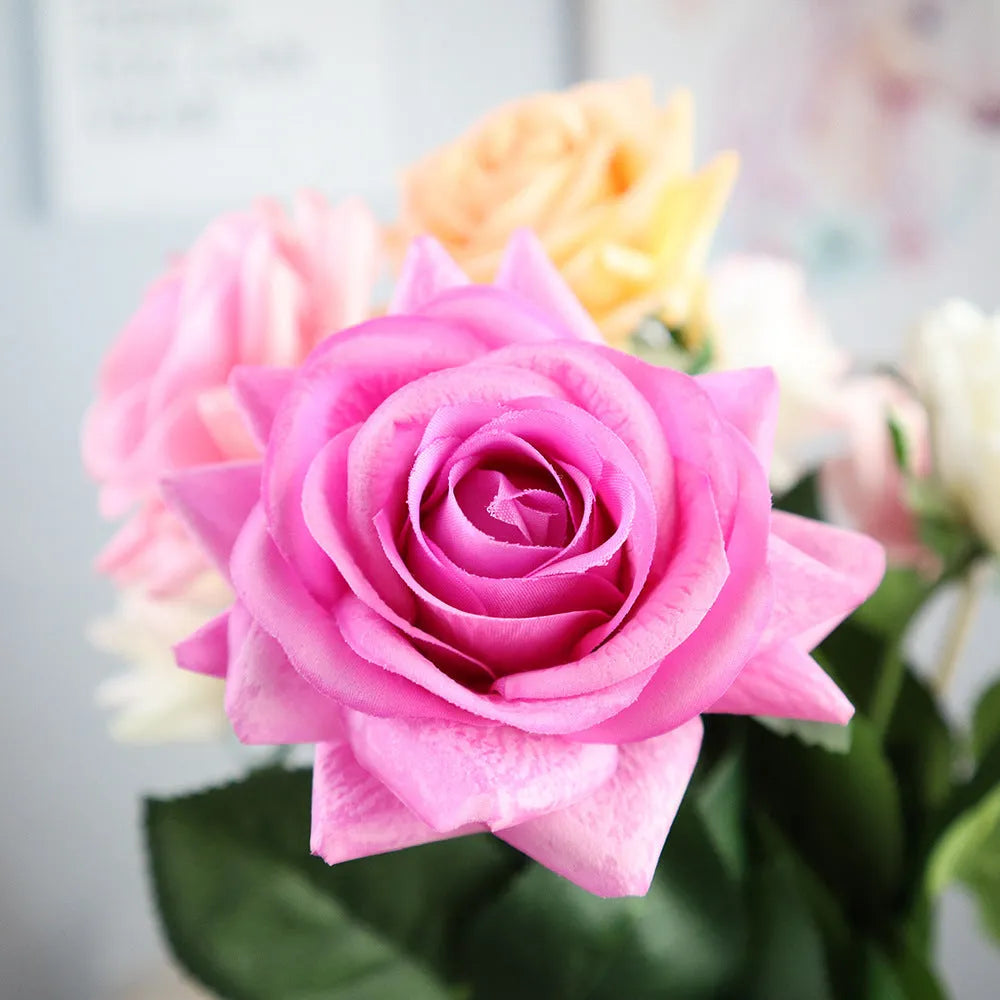 Artificial silk flower bouquet with red petals and green leaves measuring 42cm long