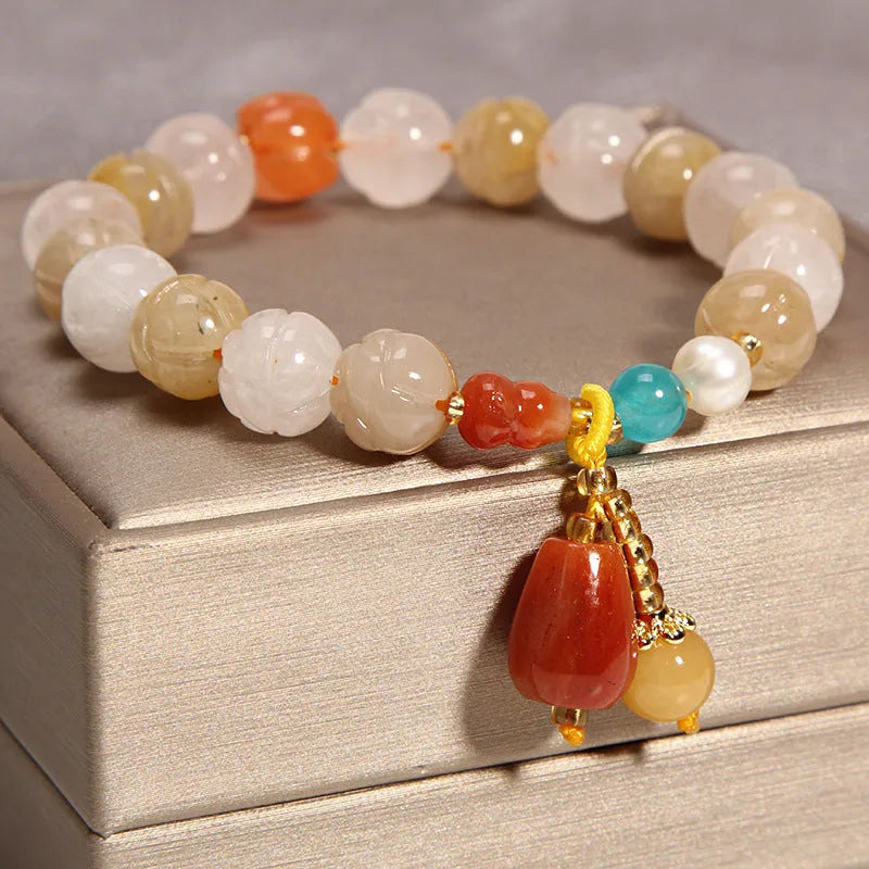 Women's yellow agate crystal bracelet with adjustable gold silk cord on wrist