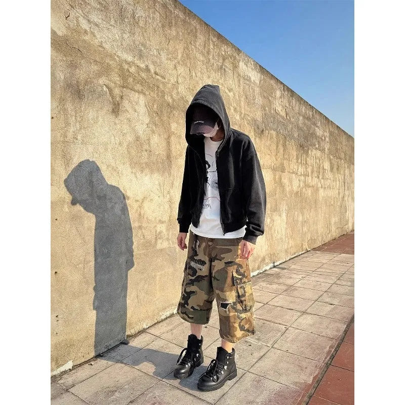 Men's loose-fit camouflage cropped jeans with ripped knees and retro patches on a straight-leg.