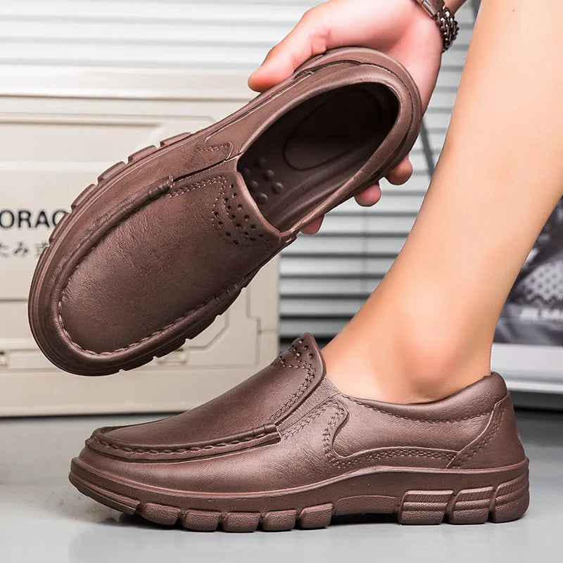 Men's slip-on work shoes in black with waterproof platform sole and mid heel, side view