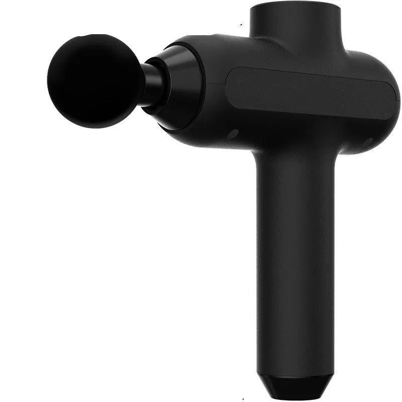 Black rechargeable muscle massager with six different coloured massage heads on a table.