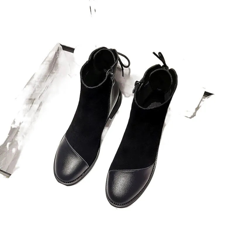 Black women's knee-high Martin boots with side zip, bow detail, and a round toe on a non-slip rubber sole.