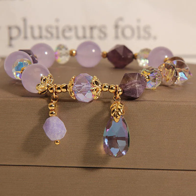 Children's crystal bracelet with lavender purple water-drop crystals on a plain background
