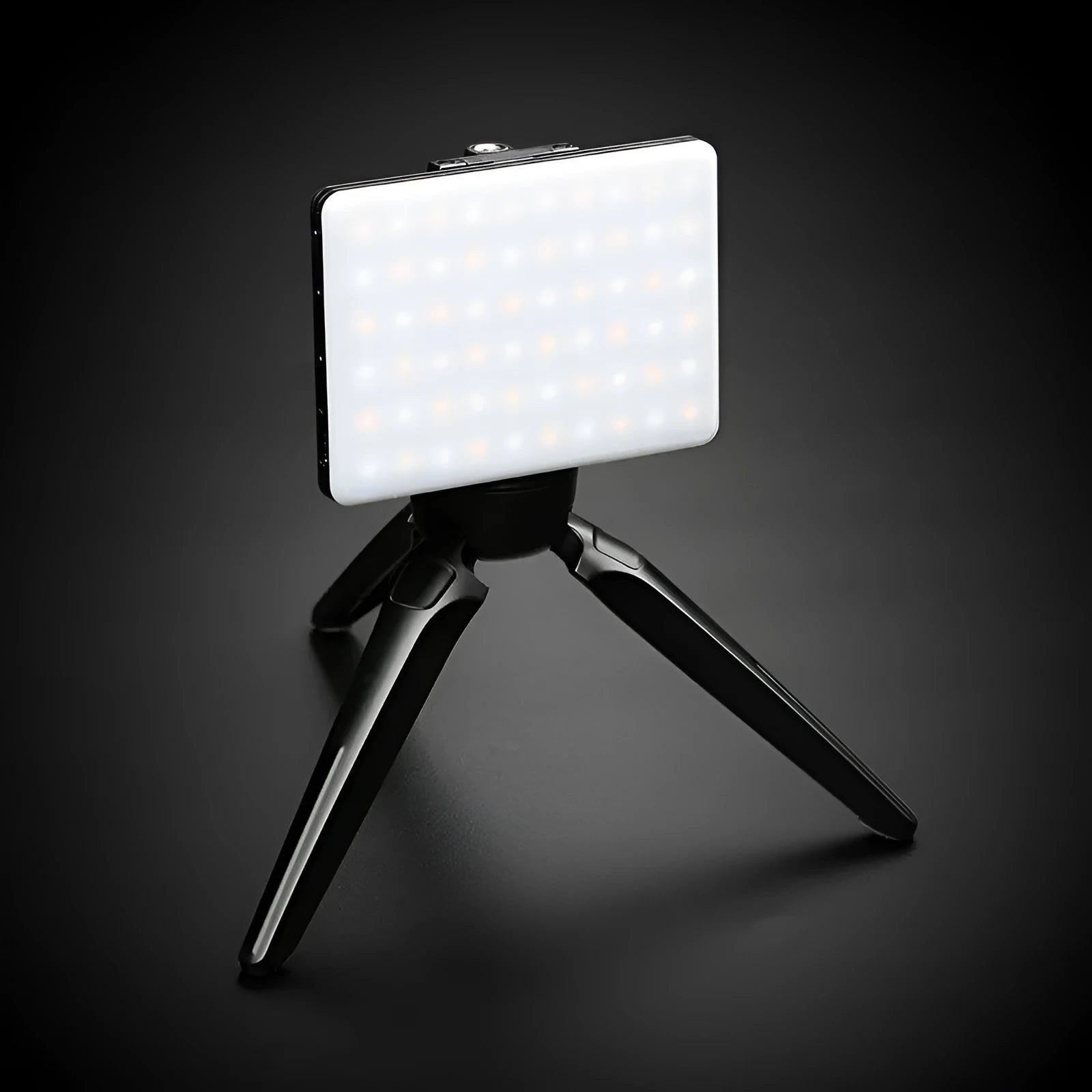 White portable LED mobile phone fill light with clip attached to a phone showing two-colour temperature modes and 250 Lux brightness
