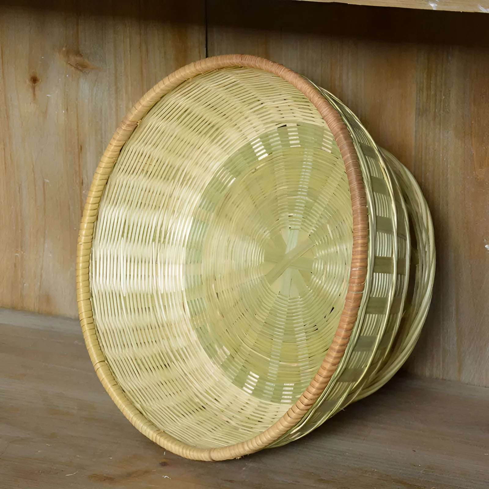 Handmade natural bamboo storage basket shown in one of three available sizes.