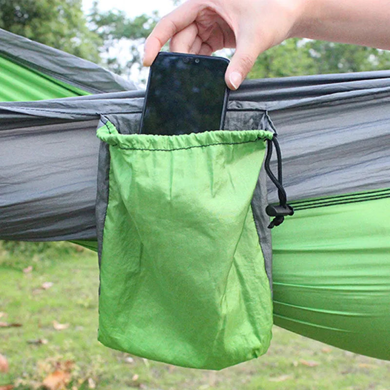 Blue nylon outdoor camping hammock with 300kg load capacity shown suspended between trees
