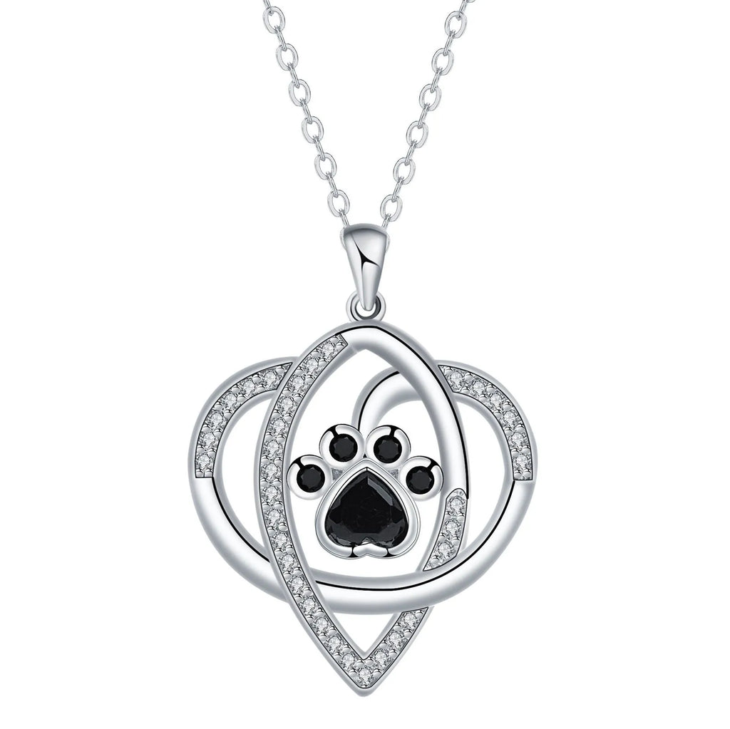 Close-up of electroplated copper paw print necklace pendant on adjustable cross chain