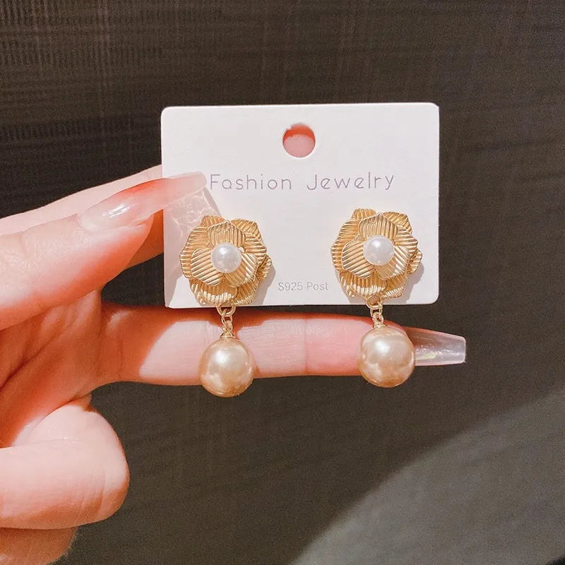 Gold electroplated alloy stud earrings with needle rose pearl design, ice flower motif, and opal stone accent