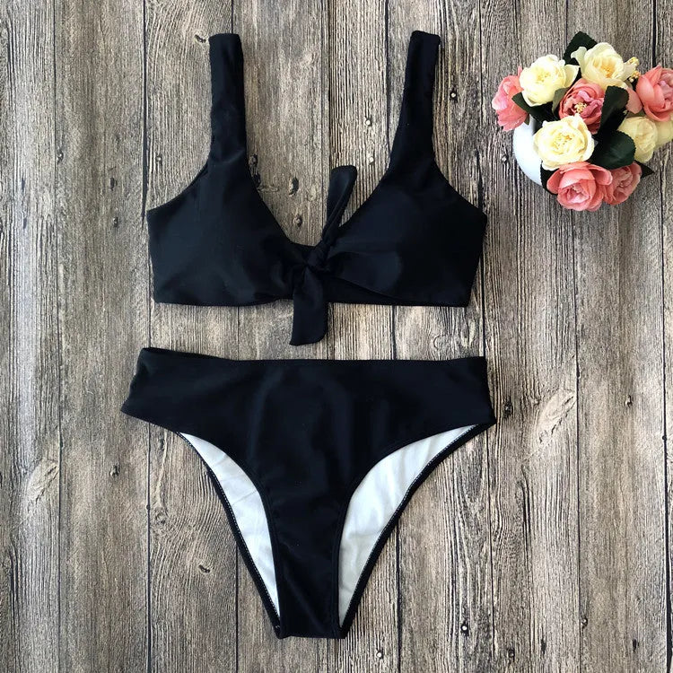 Solid colour bikini set on a hanger showing the bra and panties in a wine red shade.