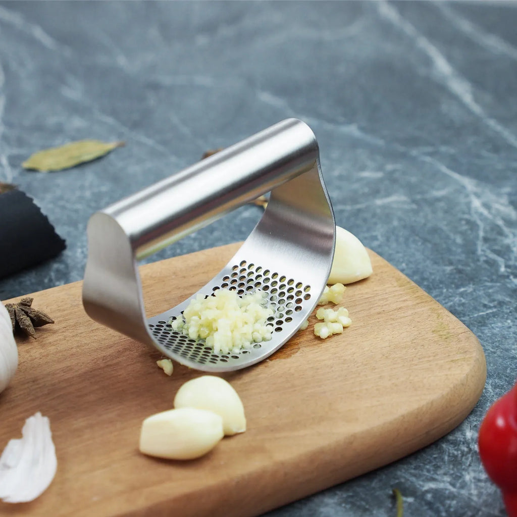 Stainless steel garlic press and onion fork kitchen bundle with PP handles on a table