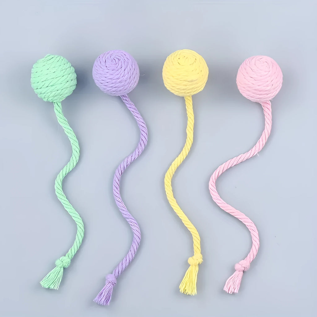 Colourful cat toy ball with attached rope and built-in bell in green, pink, purple, and yellow