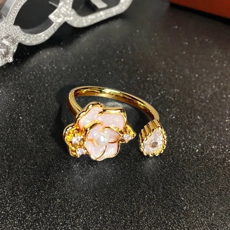 Adjustable copper ring with vintage oil dripping gourd, flower, and bow design and inlaid zircon stones.