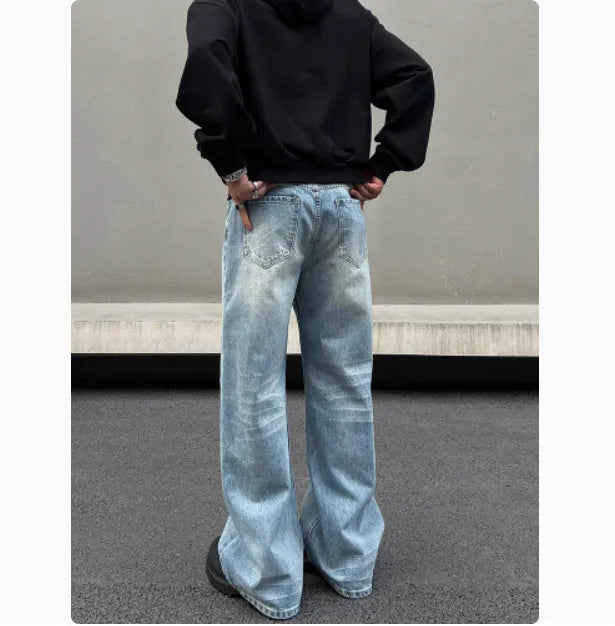 Men's retro whisker washed blue straight jeans with visible stitching and medium-high waist.
