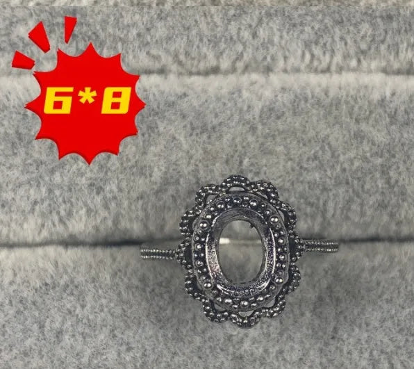Oval denier copper ring with 6x8mm stone and star design on an open mouth band.