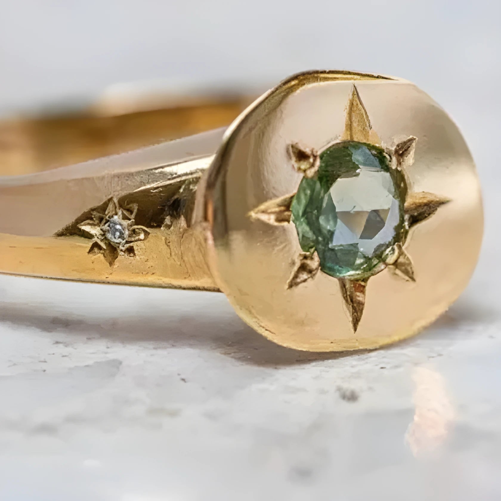 Gold coloured adjustable ring with a star-shaped zircon centre on a zinc alloy band.