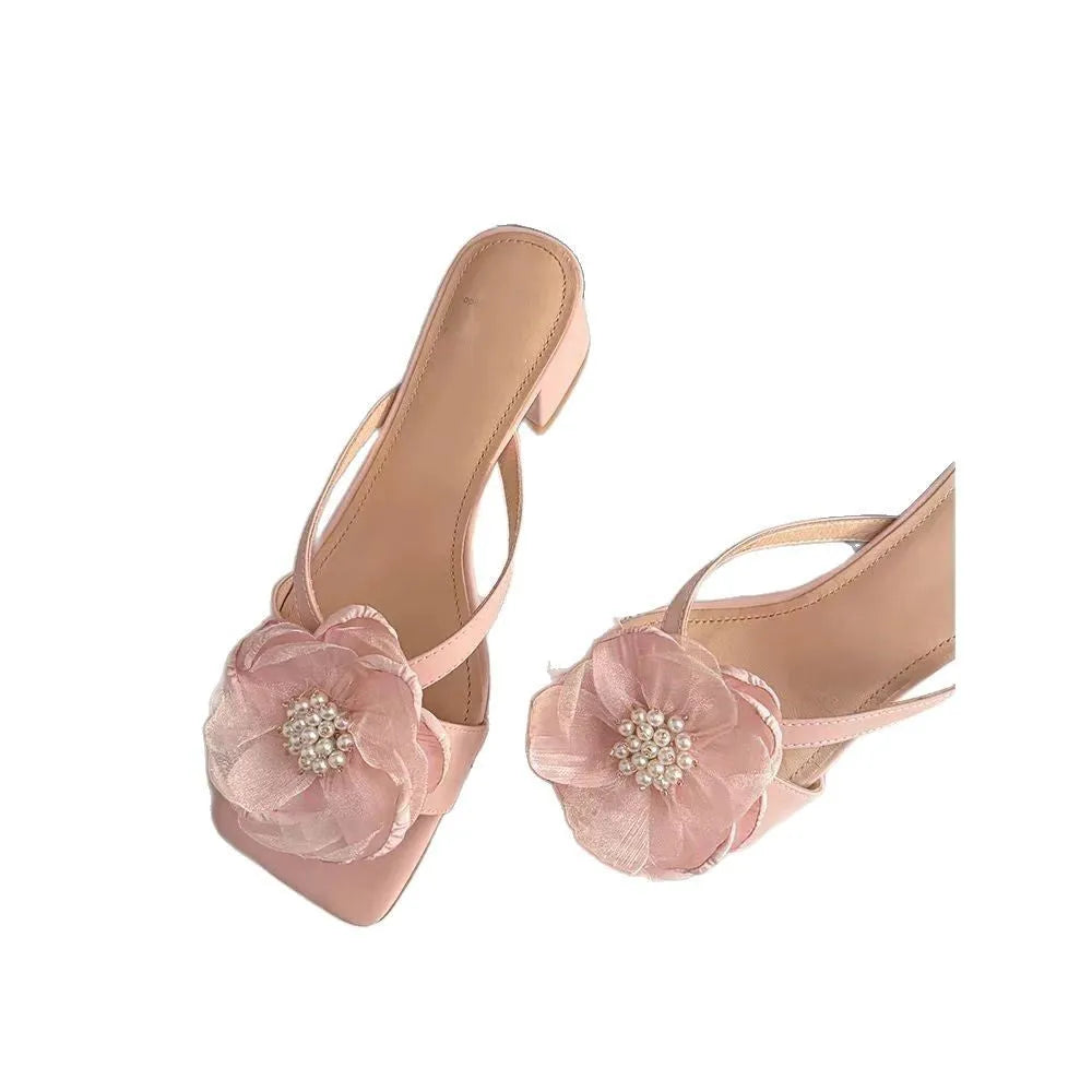 Women's chunky heel sandals with square toe, satin upper, and floral detail in cream-white.