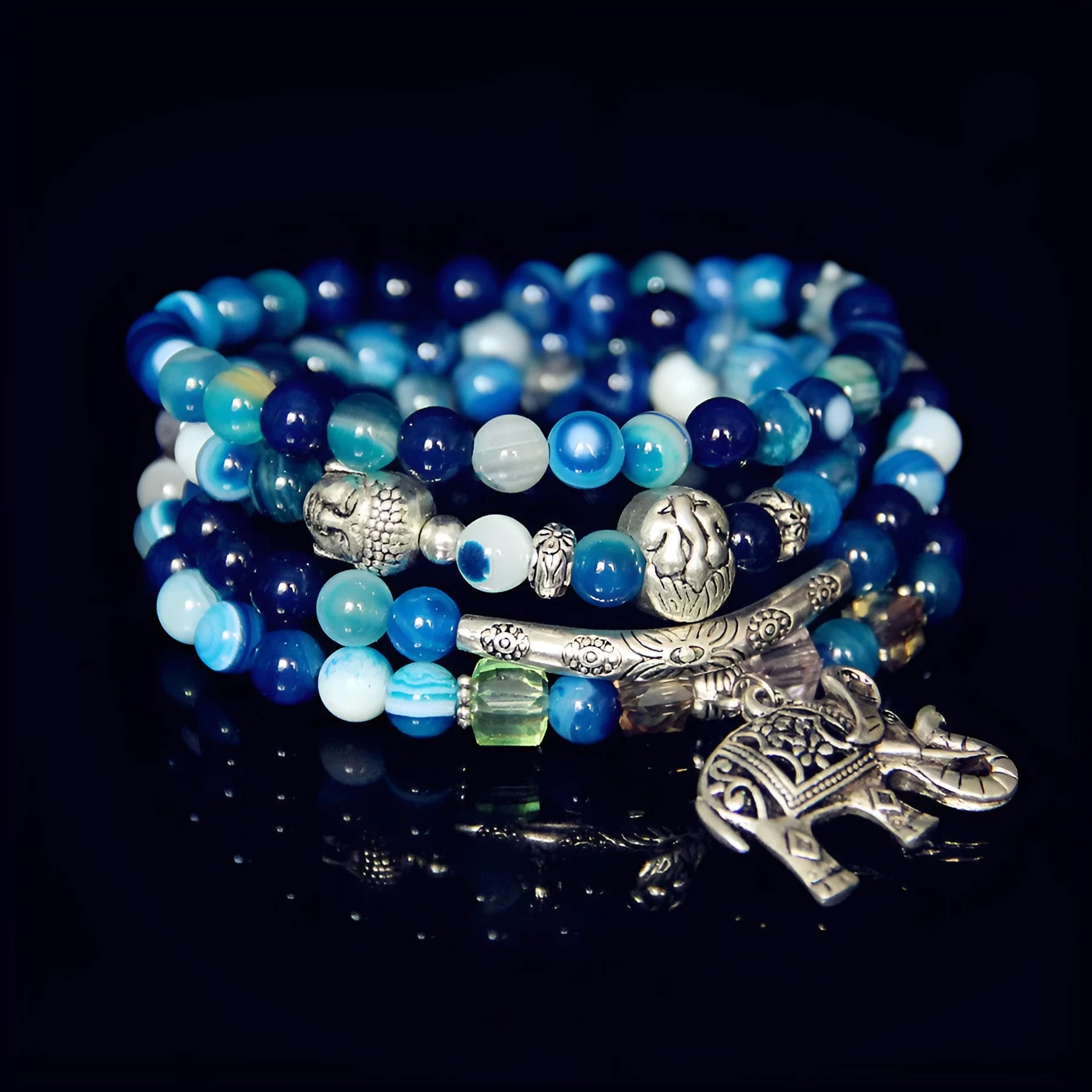 Multi-layer natural agate bracelet with 6mm beads in blue elephant pattern on a neutral background