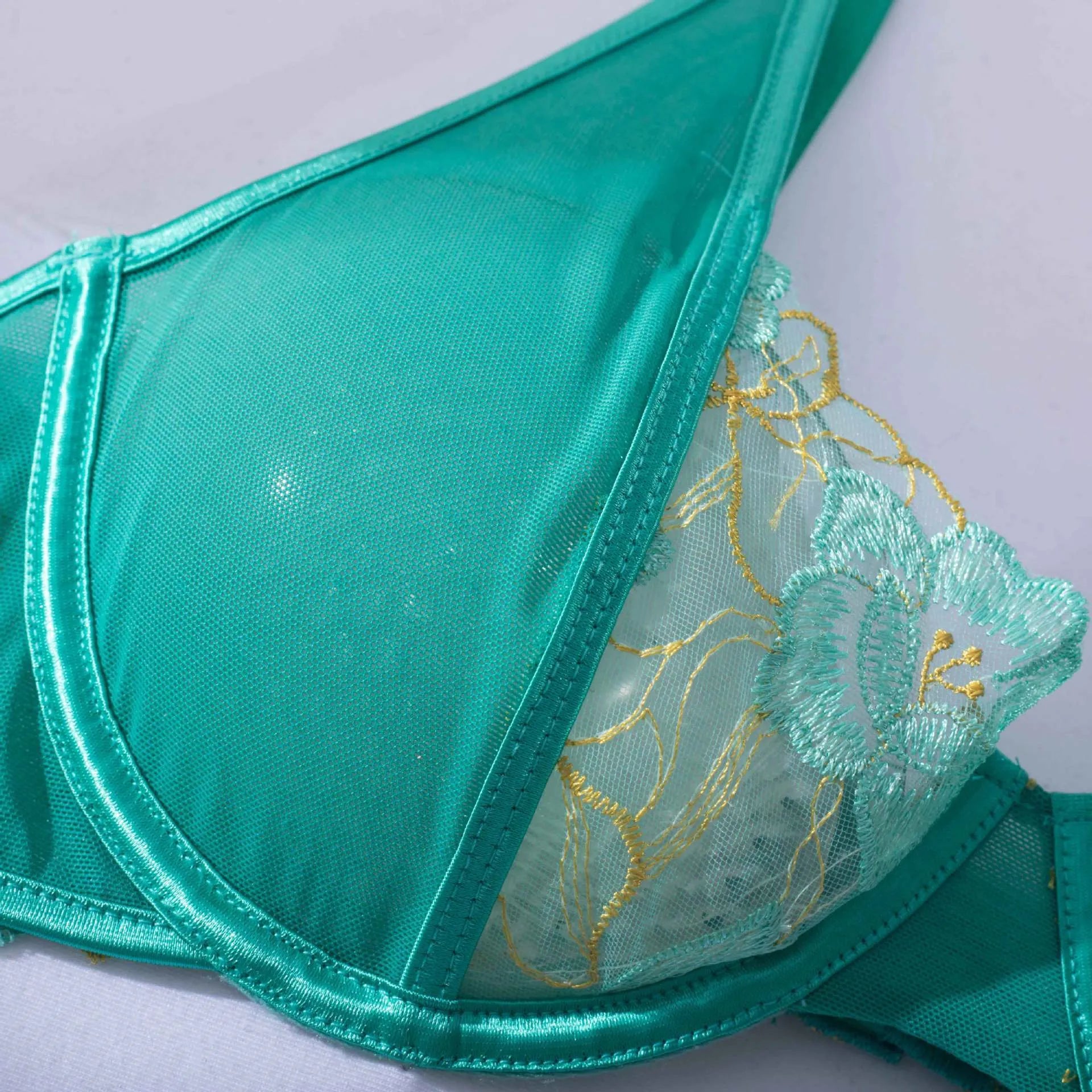 Women's light green polyester embroidered bra set with three-point tights on white background