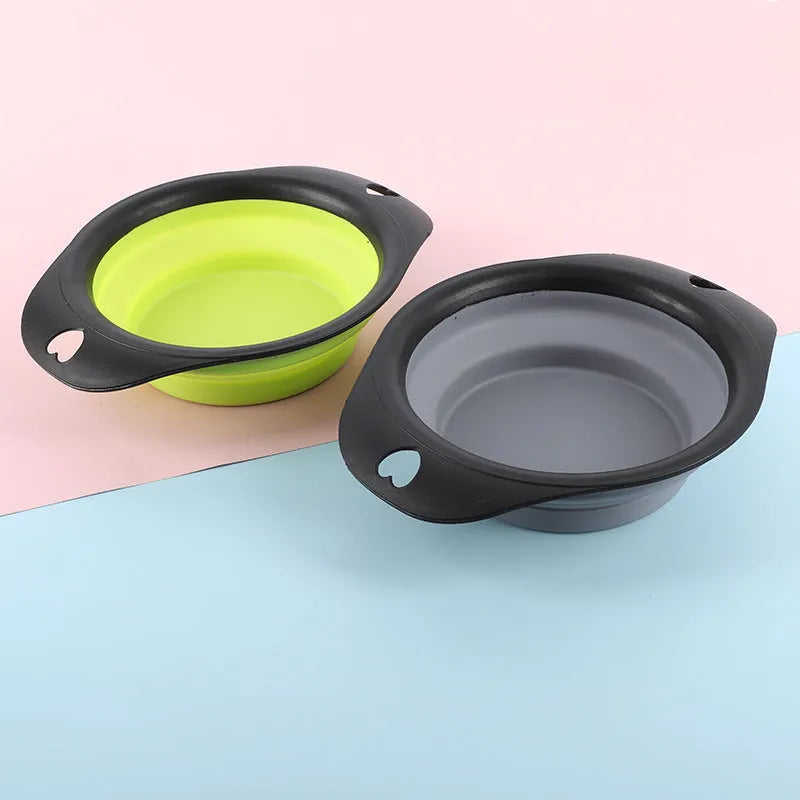 Silicone folding bowl for pets in black and green, collapsed flat for storage, portable outdoor cat and dog food bowl