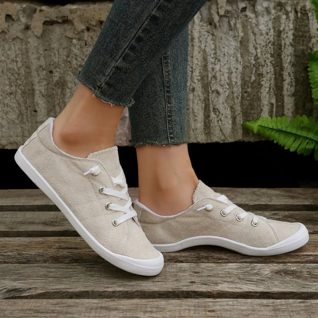 Women's beige casual sneaker with fabric upper and rubber sole on neutral background