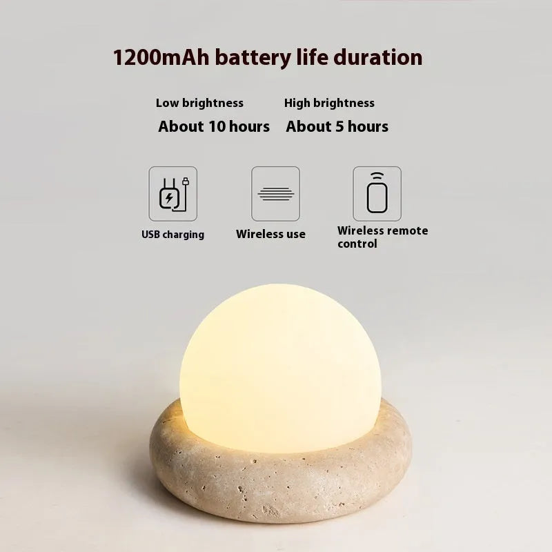 Cream modern bedside night lamp with remote control on wooden nightstand