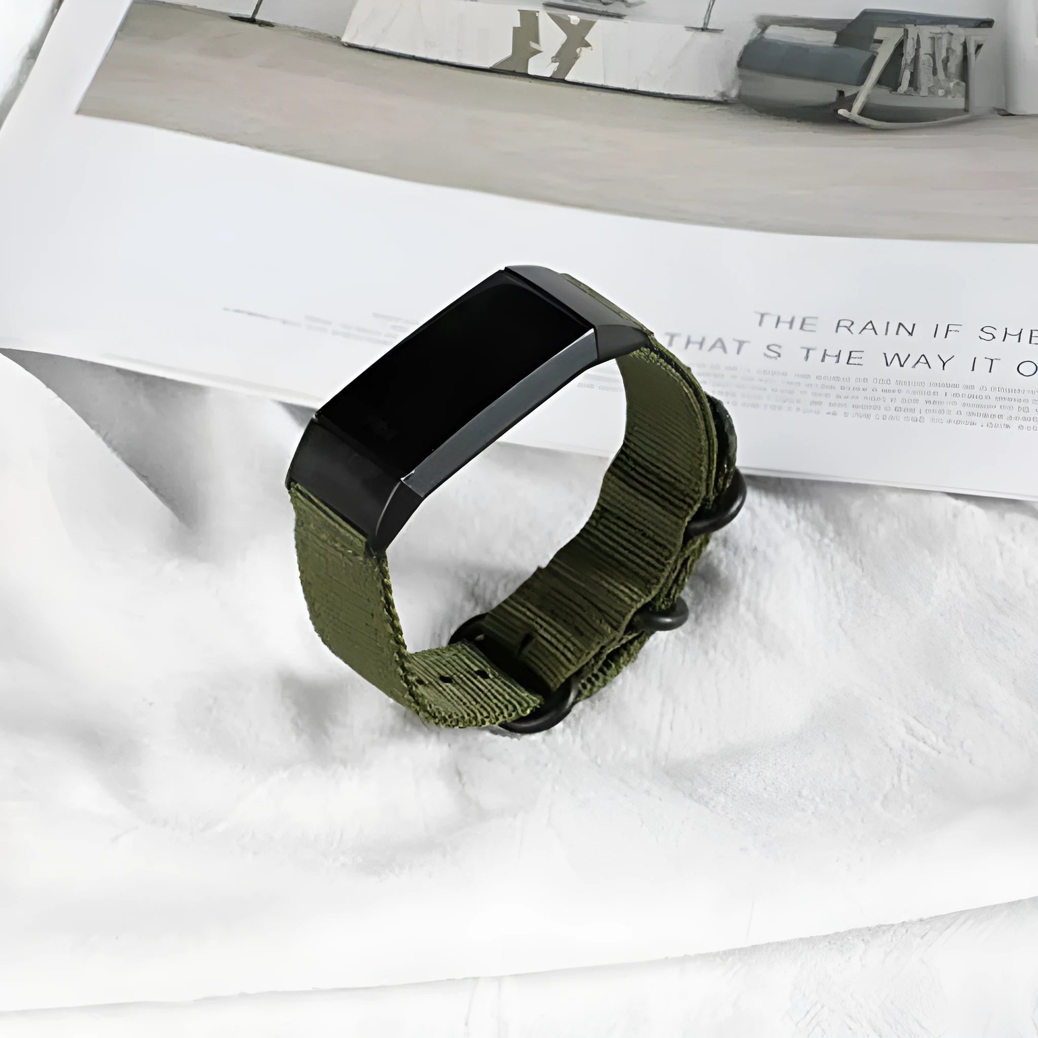 Fitbit Charge nylon replacement strap with a three-ring metal buckle shown in multiple colour options.