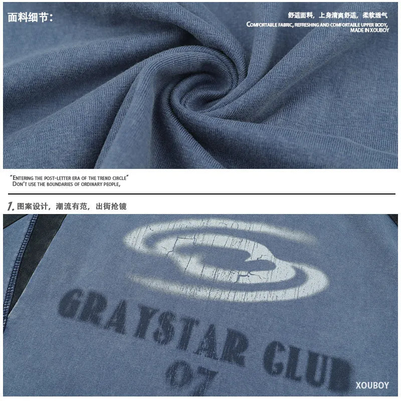 Man wearing a blue hip hop letter print t-shirt with raglan sleeves.