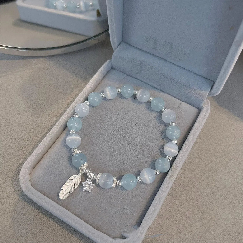 Small white girl crystal bracelet in Feather XINGX Blue Moonlight with eight Awn star and text design
