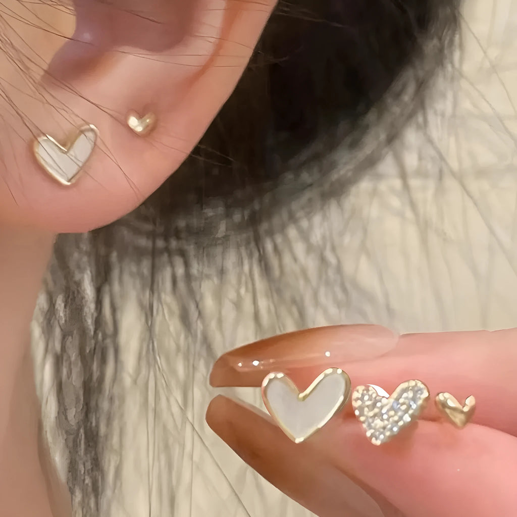 Three pairs of women's heart-shaped alloy earrings in coordinated set with electroplated finish