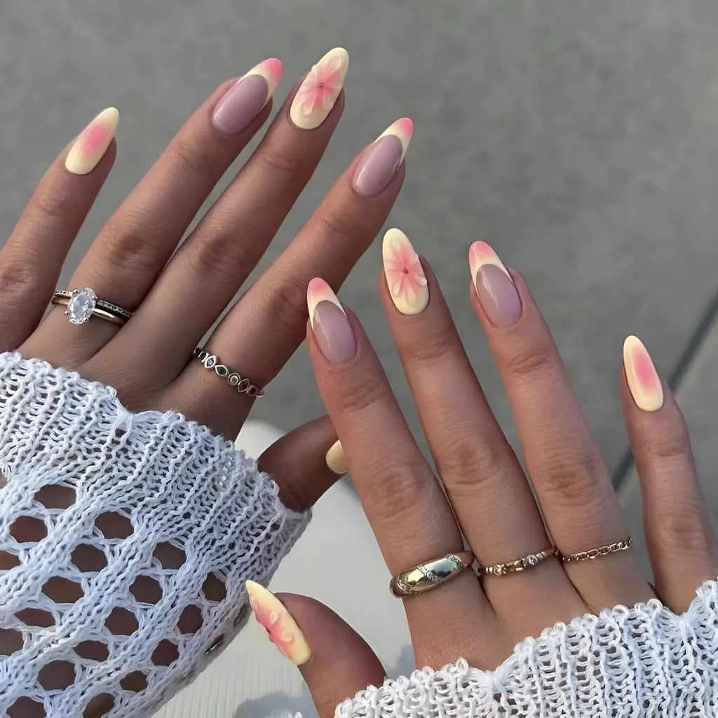Detachable fake nails with pink 3D cartoon flowers, jelly glue, and filing strip on white background