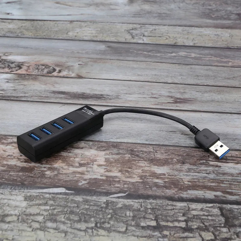 USB 3.0 hub splitter with 4 ports and black LED indicators on a desk