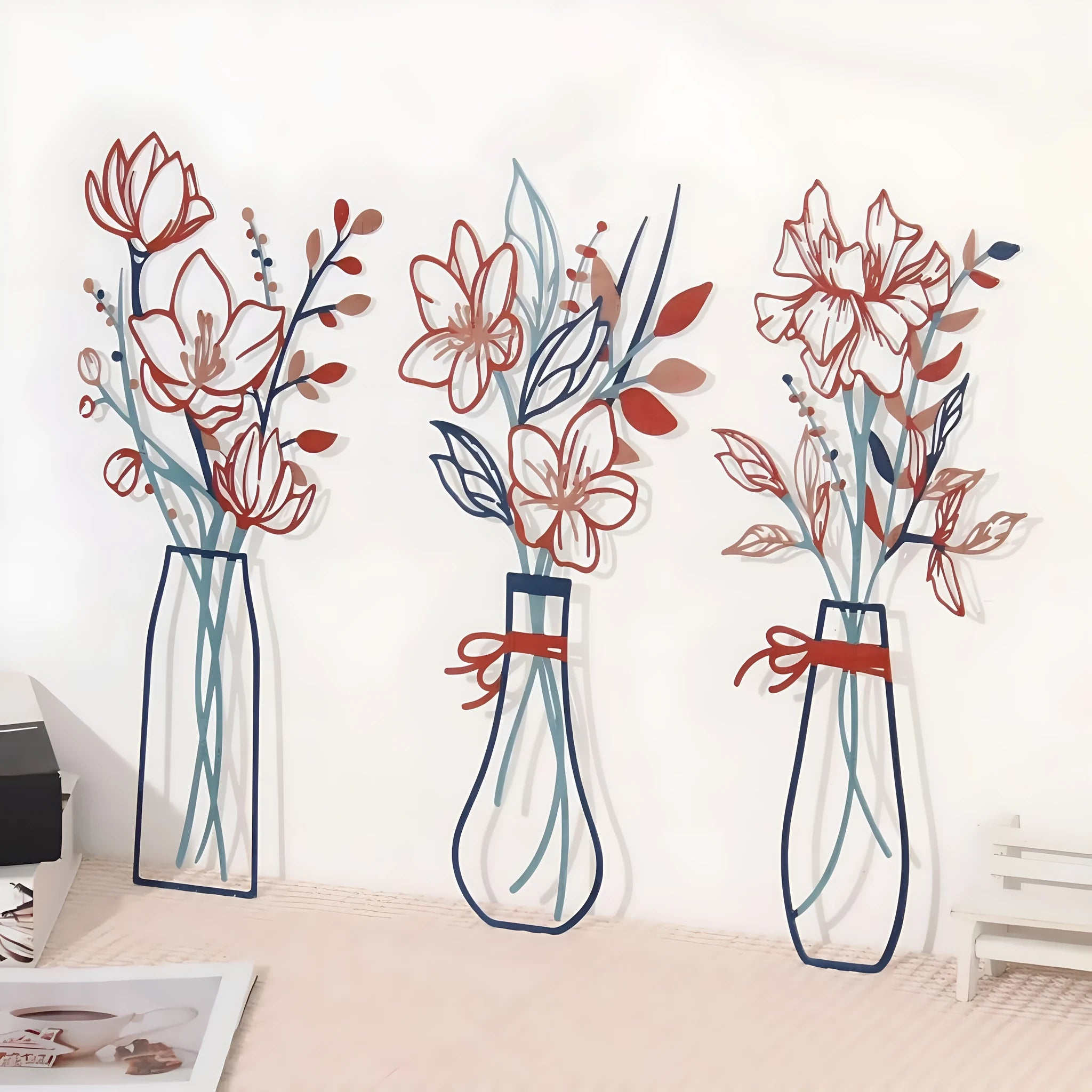 Set of three metal flower and vase wall art decorations in a modern country style.