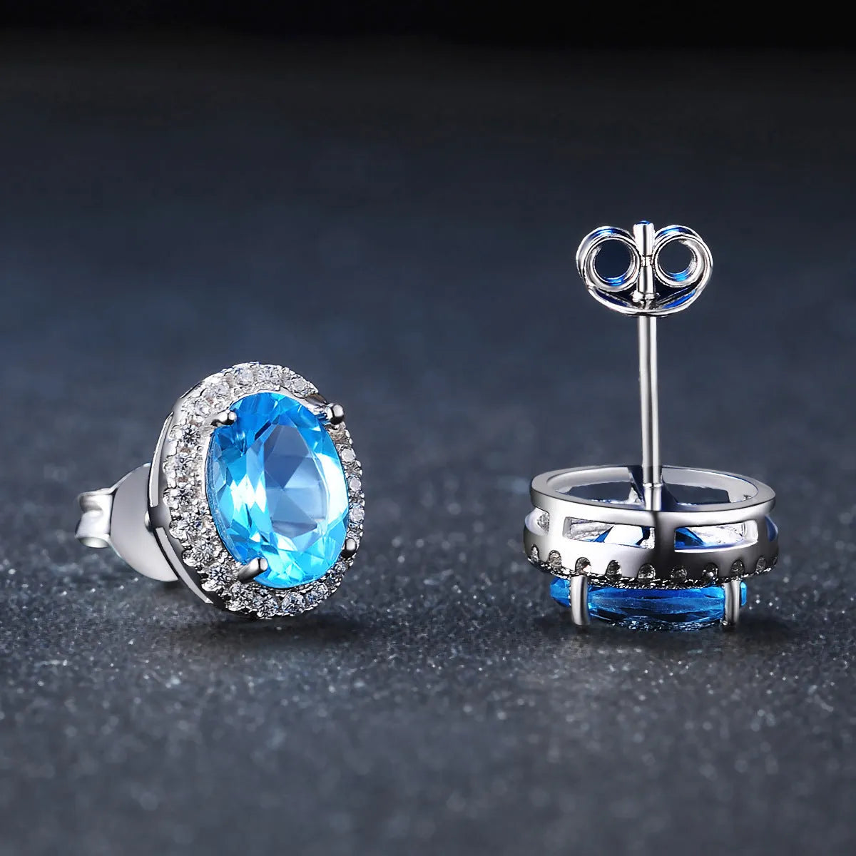 925 sterling silver jewellery set with blue topaz gems showing earrings, ring, pendant, and necklace with geometric design