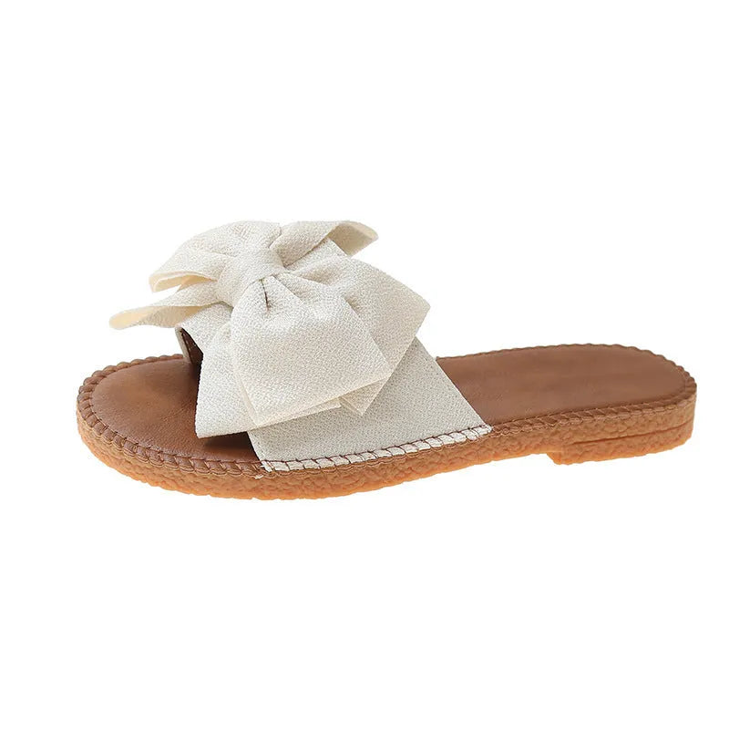 Women's slip-on suede sandals with bow detail, flat heel, rubber sole – beige colour option