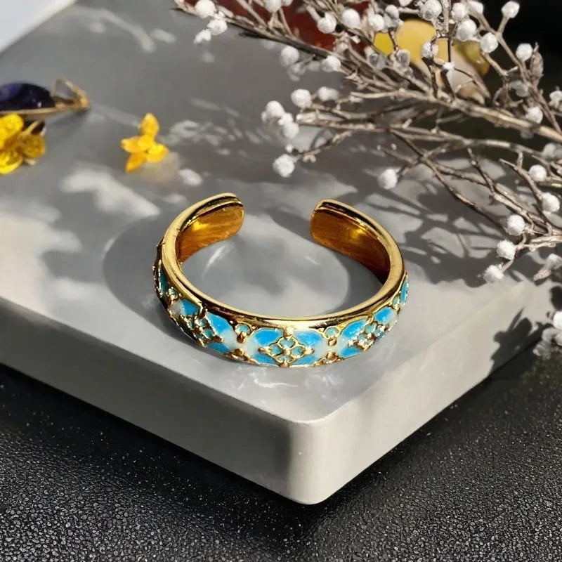 Adjustable copper ring with vintage oil dripping gourd, flower, and bow design and inlaid zircon stones.