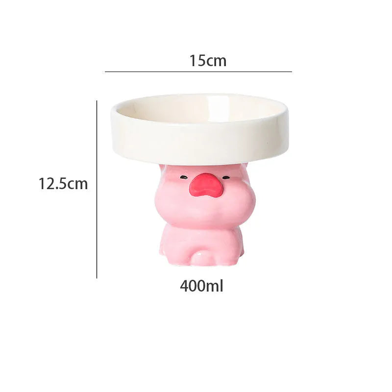 A raised ceramic cat bowl in an animal design, showing its height and wide opening for whisker-friendly feeding.
