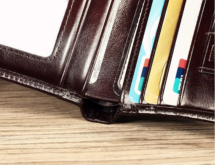 Men's black leather wallet open to show internal compartments for banknotes, cards, coins, and a concealed dark space.