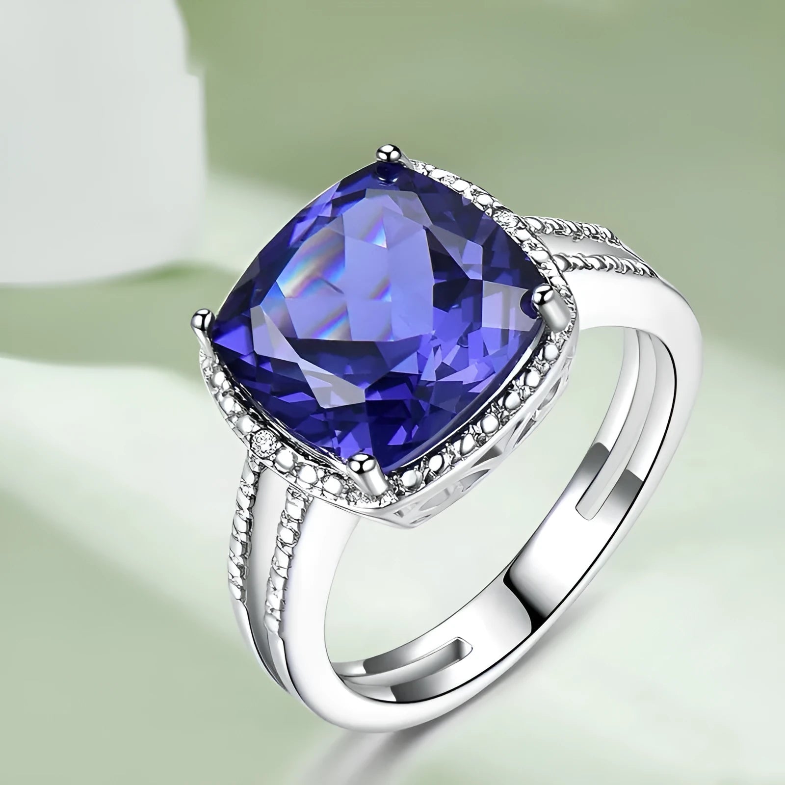 Blue Tanzanite gemstone set in a sterling silver women's ring on a white background.