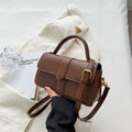 Women's beige PU messenger bag showing internal file organisation and sandwich pocket exterior