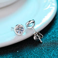 A pair of geometric 925 silver earrings plated with Pt950 gold, featuring a choice of moissanite or zircon gemstones.