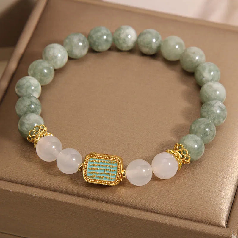 Oil green emerald crystal bracelet with five faceted beads on a string for women.
