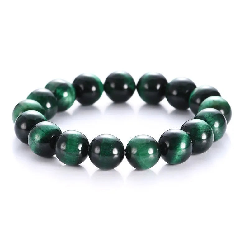 Green polished Tiger Eye stone bracelet with geometry beads, shown on a wrist.