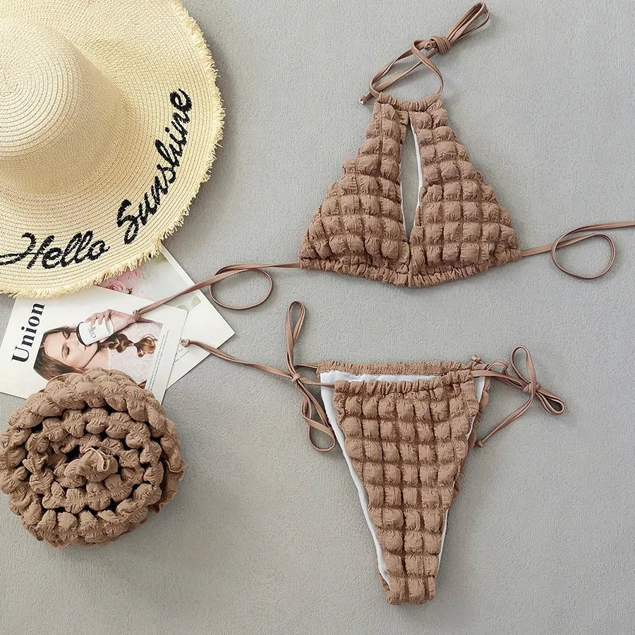Woman wearing brown seersucker lace-up three-piece bikini swimsuit with separate skirt